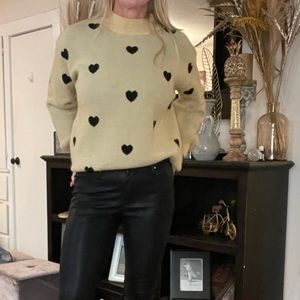 Heart sweater. Black and tan. New . Sizes medium thru extra large